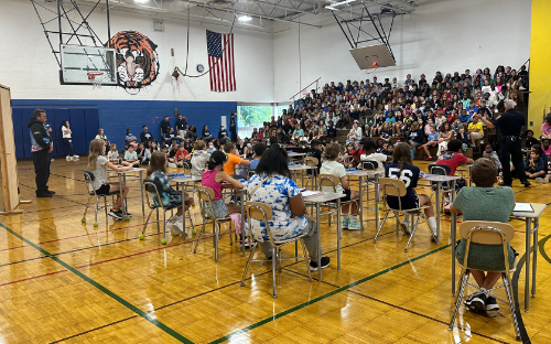 students sitting at desks in the auditorium