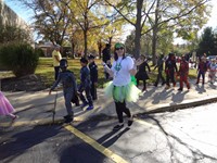 Students and teachers marching in Fall Harvest Party Parade.
