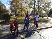Students marching in Fall Harvest Party Parade.