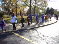 Students marching in Fall Harvest Party Parade.