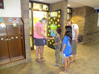 Teacher greeting student and family.
