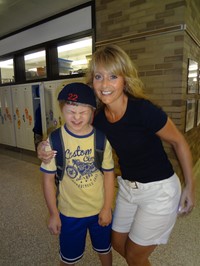 Teacher and student posing for picture.