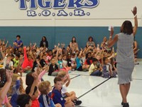 Principal talking to students at assembly.