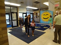 Students walking in with teacher.