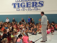 Principal talking to students about events at school.