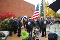 Flag ceremony honoring veterans outside of school building