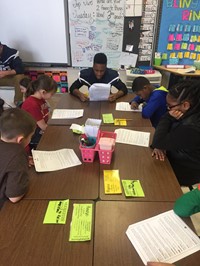 Students reading with Football players