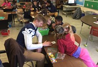 Students reading with Football players