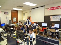 Football players helping in computer lab