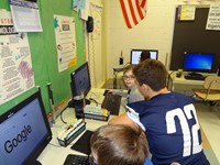 Football players helping in computer lab