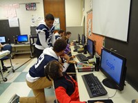 Football players helping in computer lab