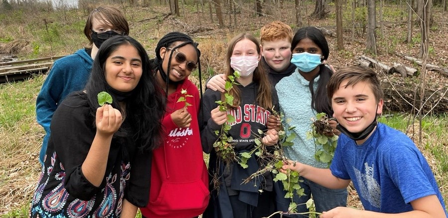 students holding plants