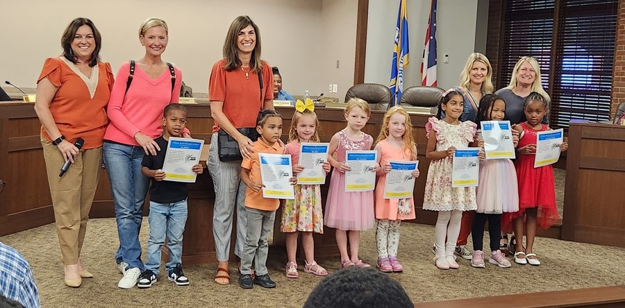 students of the month holding certificates