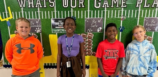 students standing in front of bulletin board