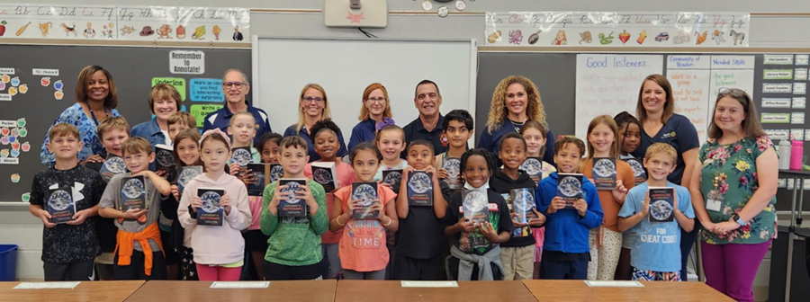 students holding dictionaries