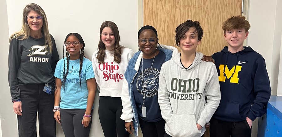 School Counselor and students wearing college gearn
