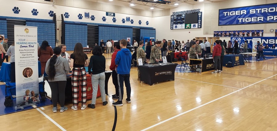 Students attending an exploration fair in the high school gymnasium